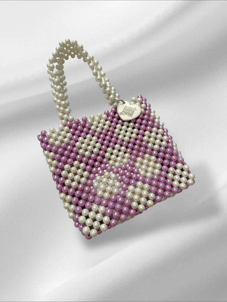 Handbag made of pearl-like bead and acrylic beads on a white background