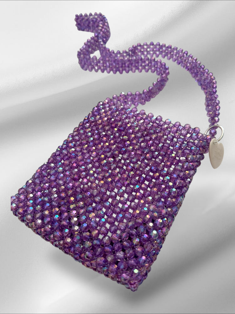 Purple beaded handbag with a hand beaded strap on a white background