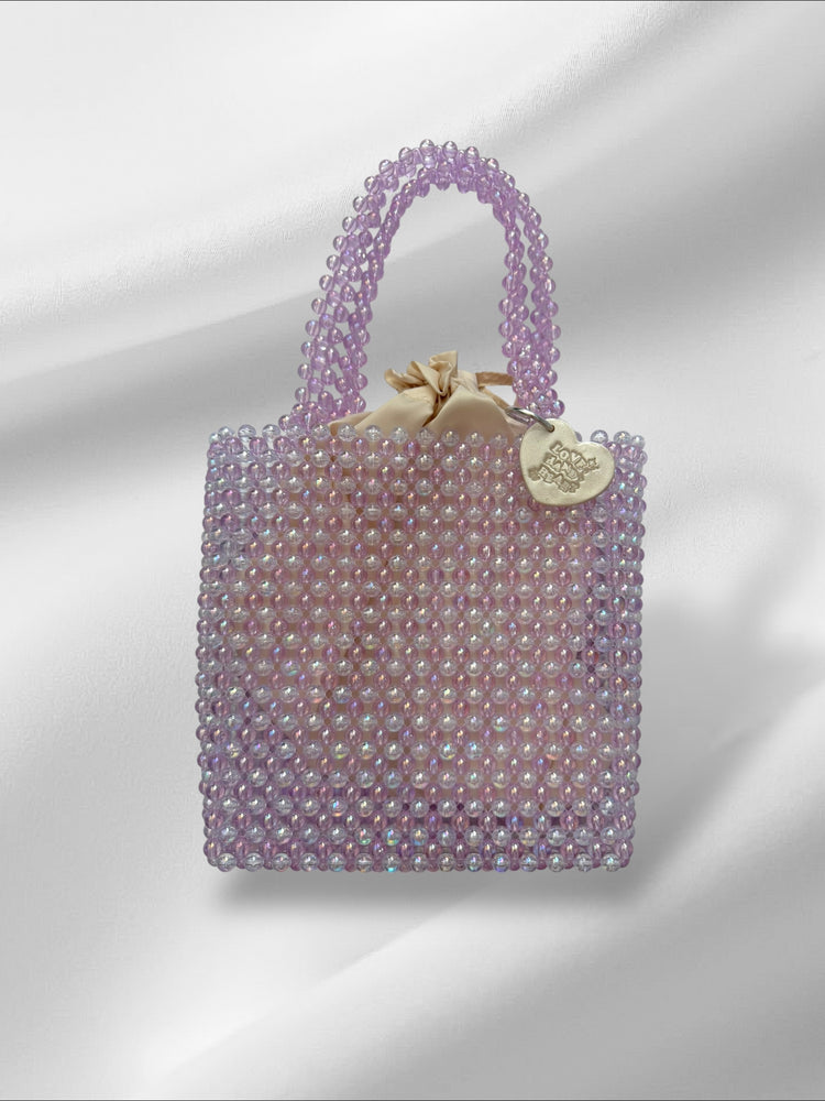 Striped beaded handbag with a tag on a white background