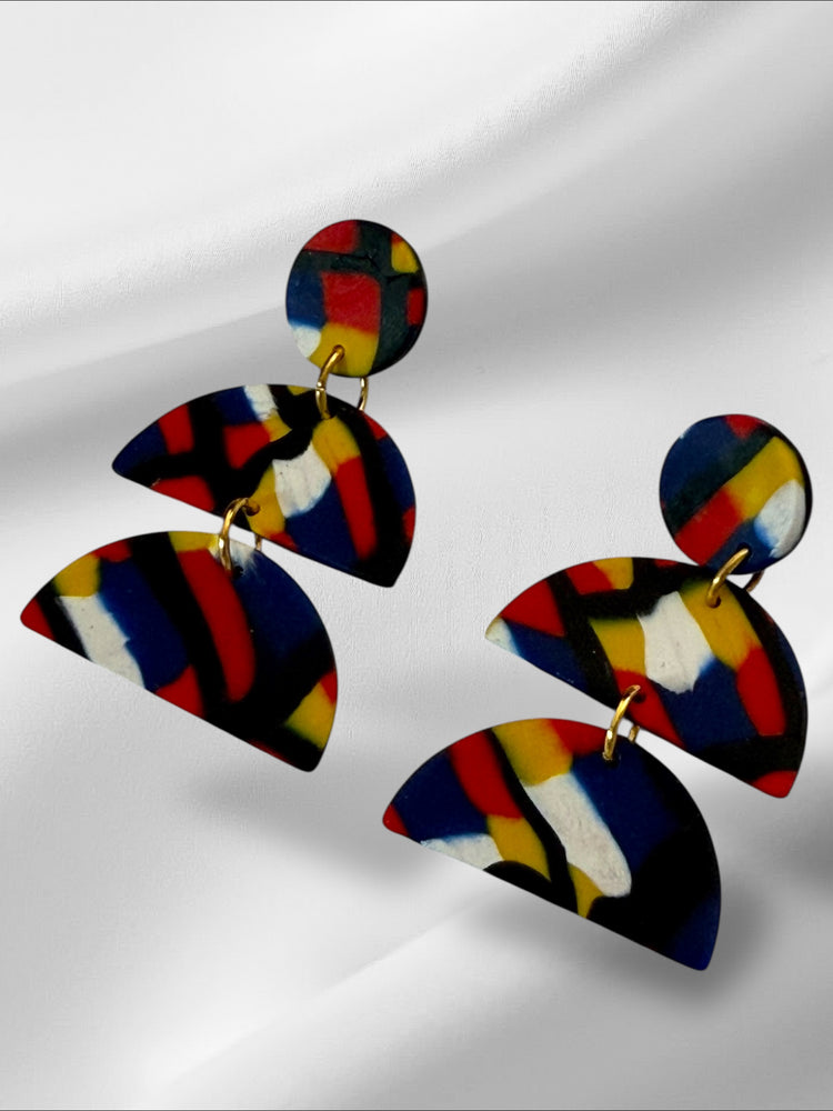 Colorful abstract earrings on a white background