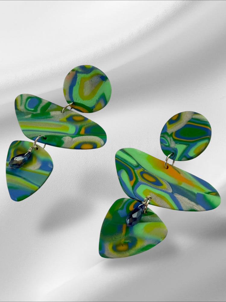 Colorful abstract earrings on a light gray background