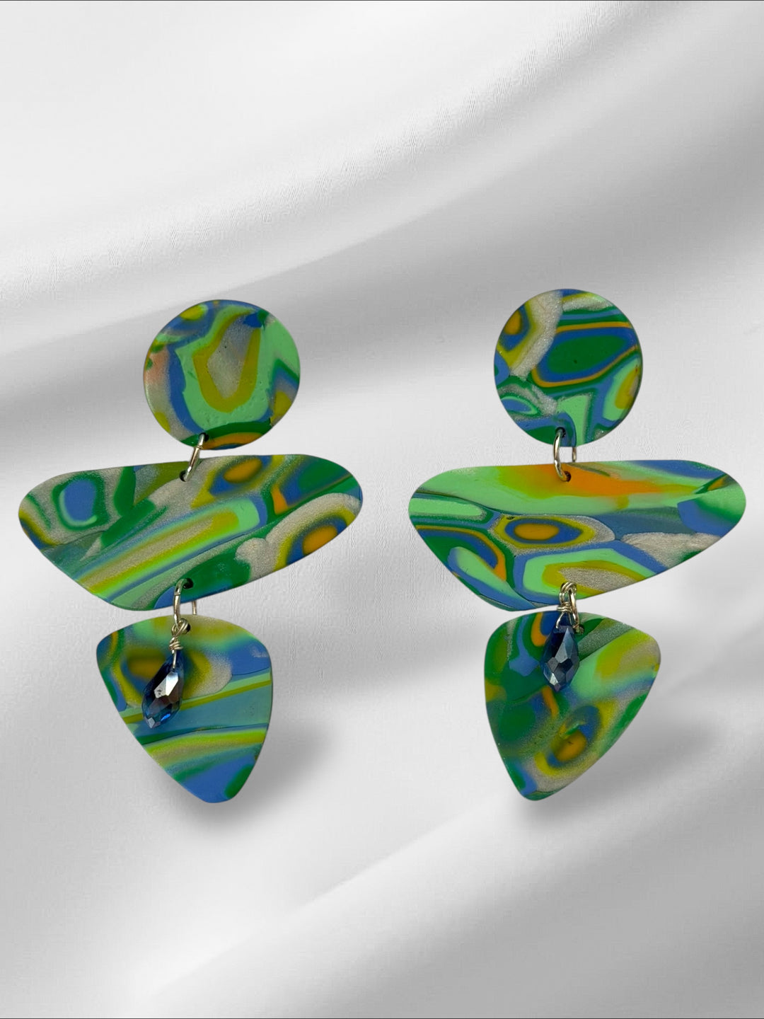 Colorful layered earrings on a white background