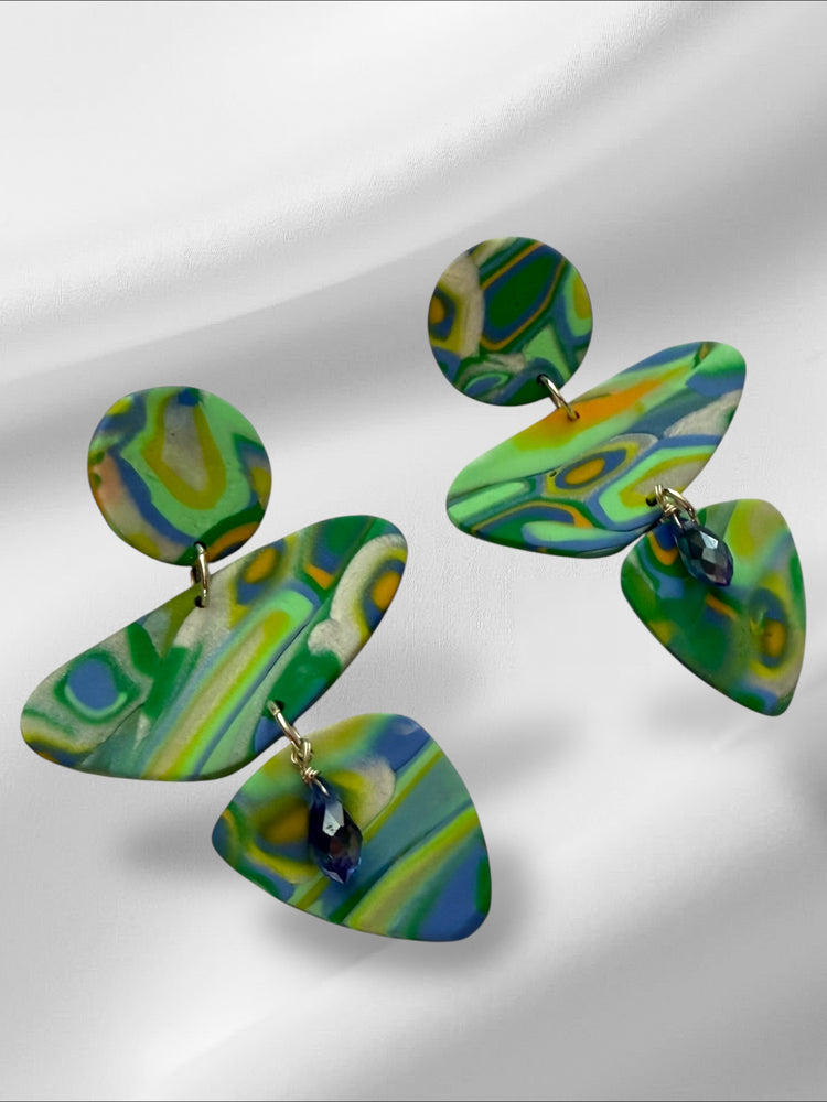 Colorful marbled earrings on a light gray background