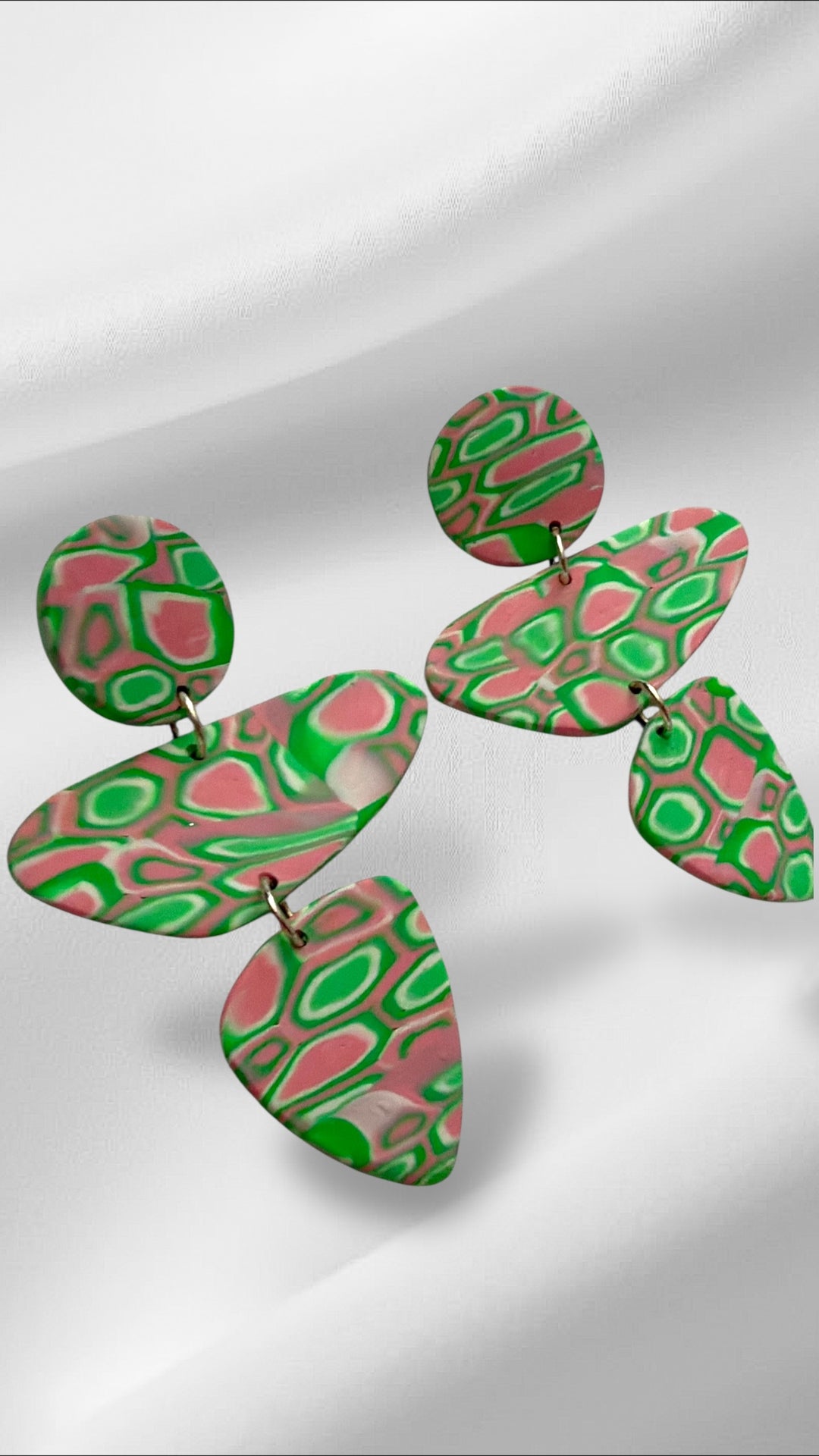 Colorful abstract earrings on a light gray background