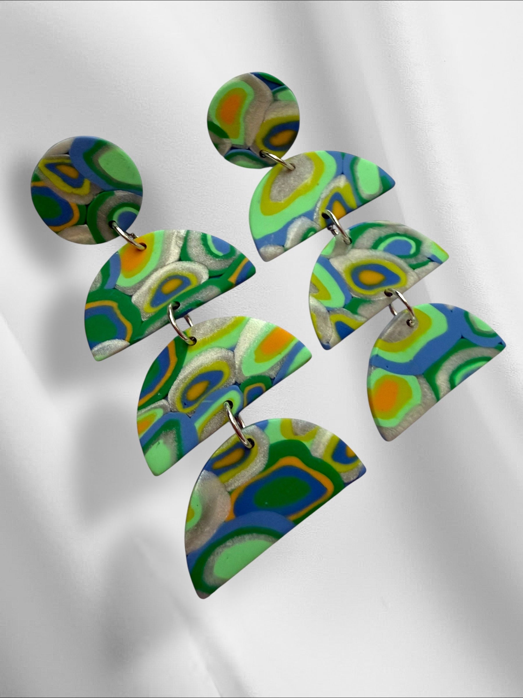 Colorful polymer clay earrings on a white background