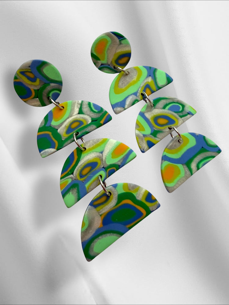 Colorful polymer clay earrings on a white background