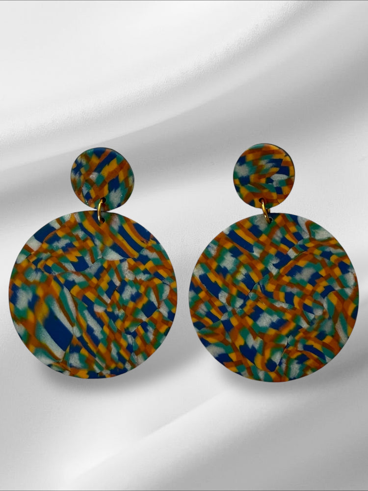 Pair of colorful round earrings on a light gray background