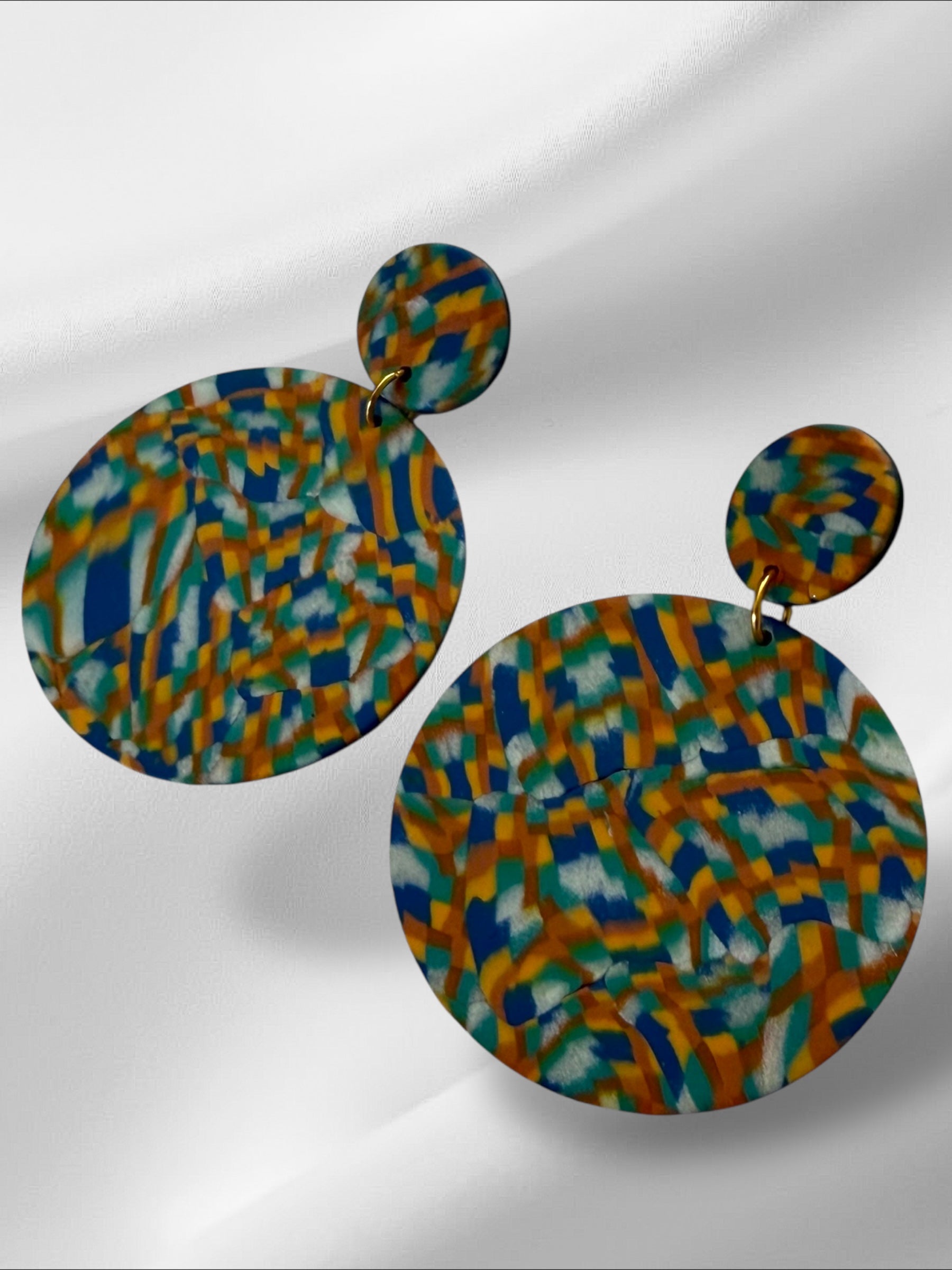 Colorful patterned earrings on a white background