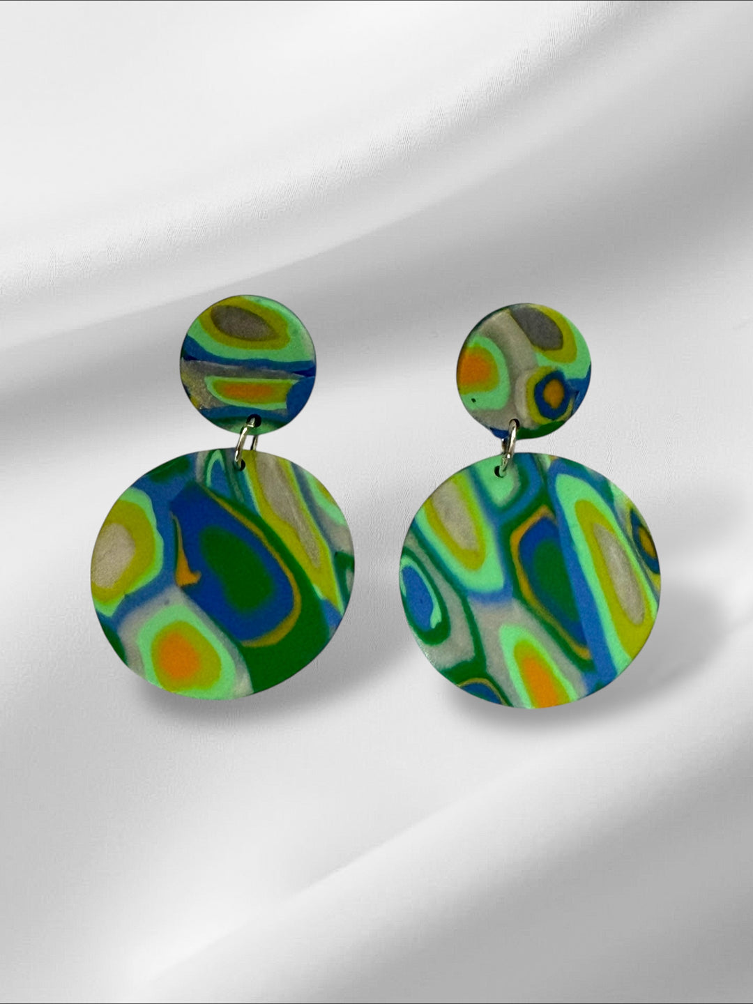 Colorful round earrings on a white background