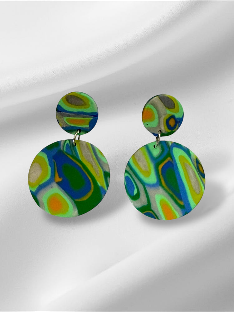Colorful round earrings on a white background