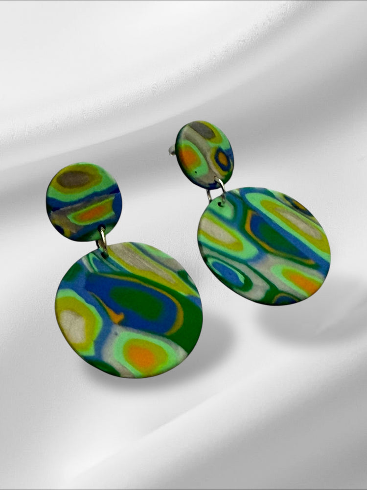 Colorful circular earrings on a white background