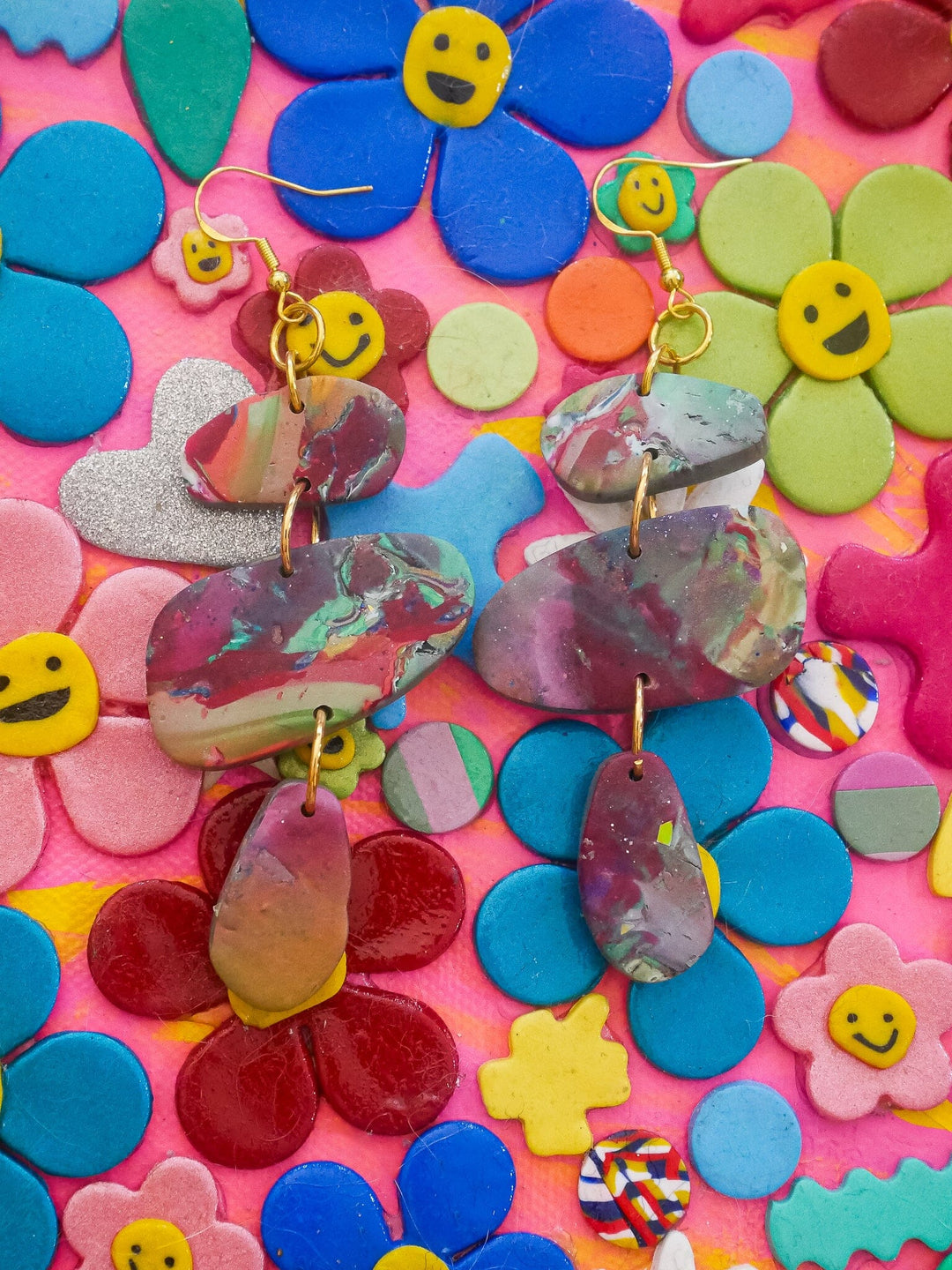 Detailed view of Red Multicolor Marble Stackers Handmade Earrings against a polymer clay art backdrop, highlighting the marble design.